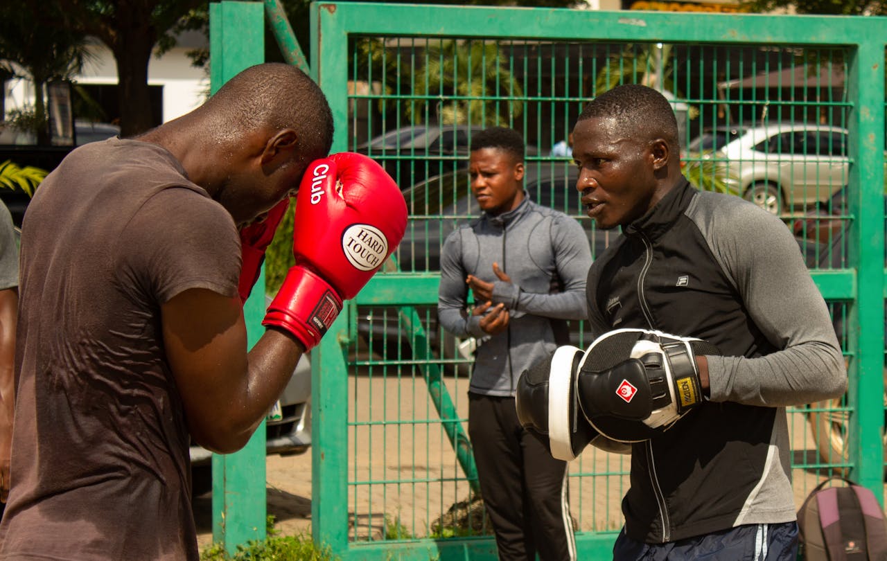 Intense outdoor boxing practice with athletes training in Abuja, Nigeria.