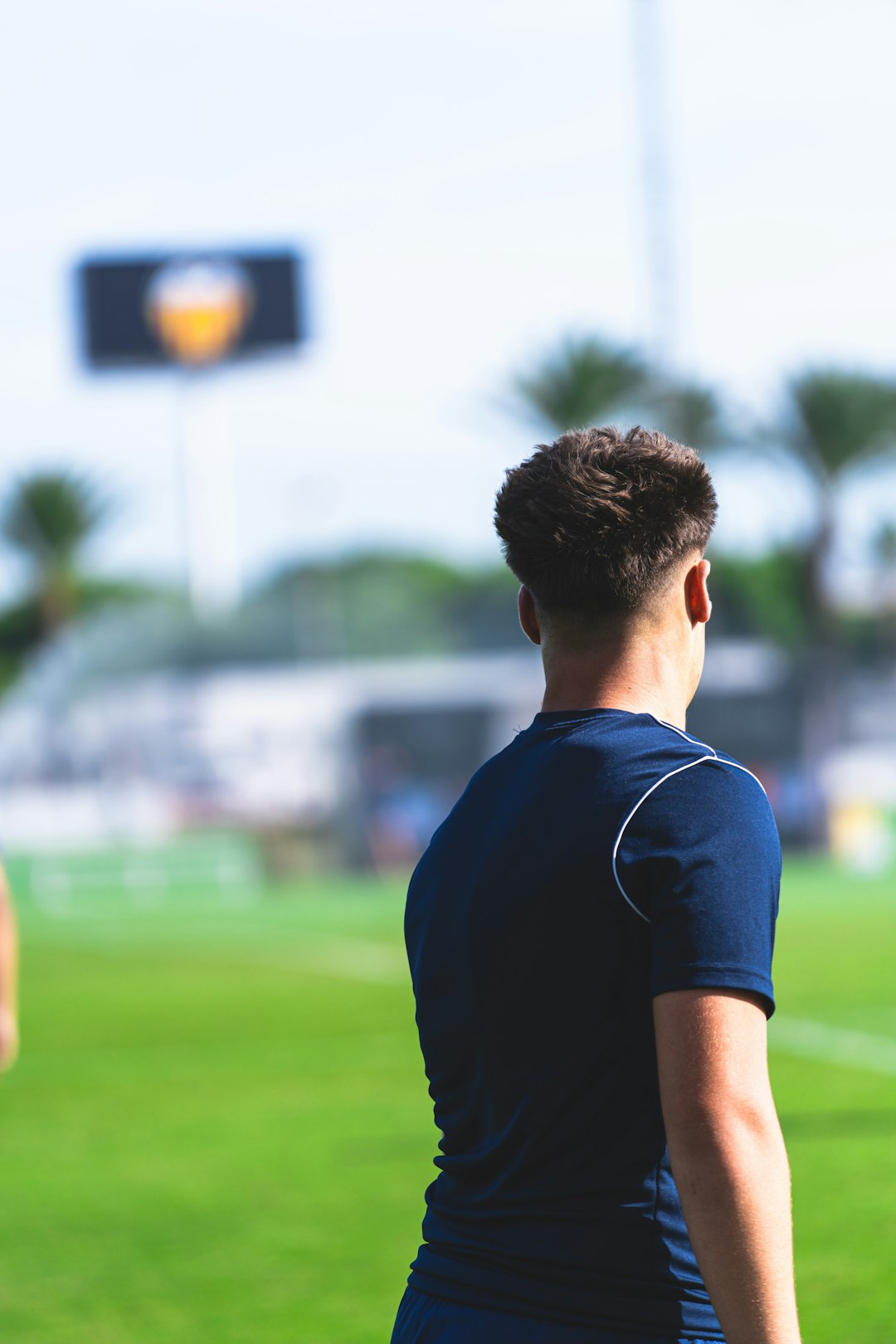 young-man-on-a-soccer-field-with-stadium-in-background-g3awux3vviu